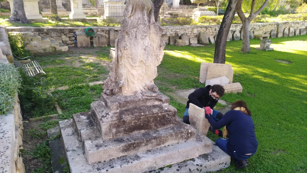Our volunteers working on a piece of the original plinth, lucky discovered  buried in a flower bed.