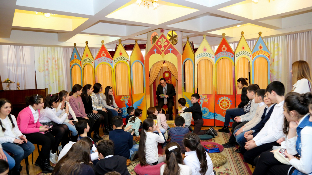 France cultural attaché to Armenia Alex Bortola reads a French fairy tale for kids at Khnko Aper National Children's Library