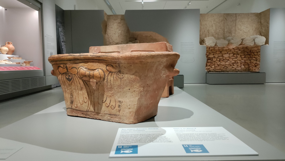 A clay bathtub larnax adorned with two octopuses invite us to think how many octopuses should be on our plate.