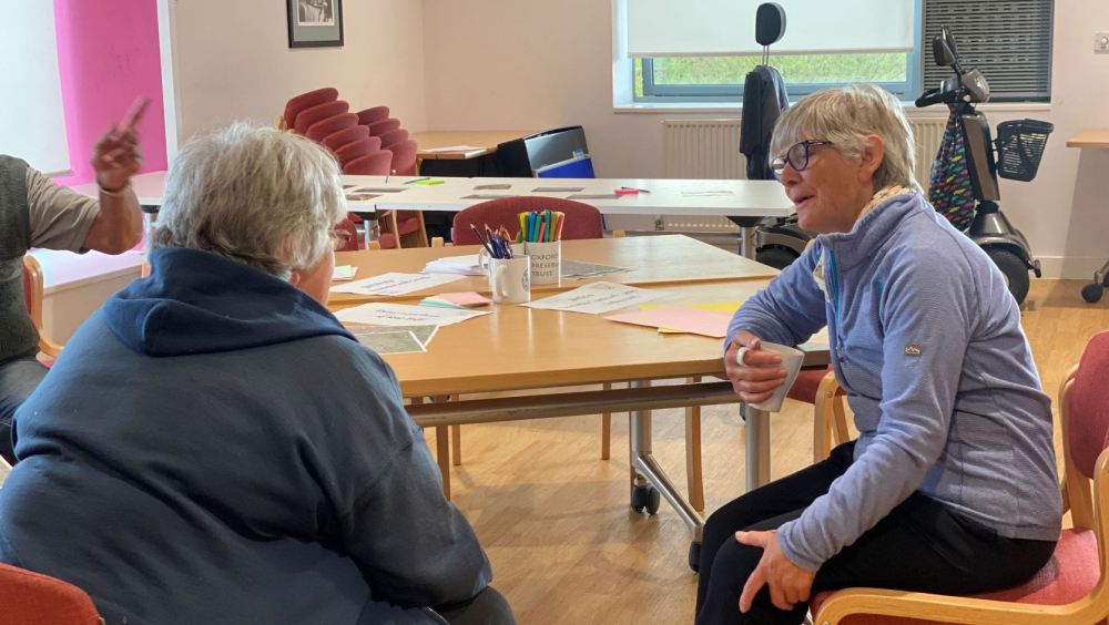 two ladies sitting down and chatting in the Rose Hill community centre