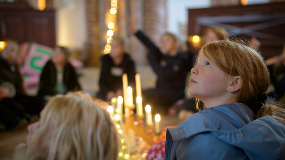 Children looking at the church with many cozy lights
