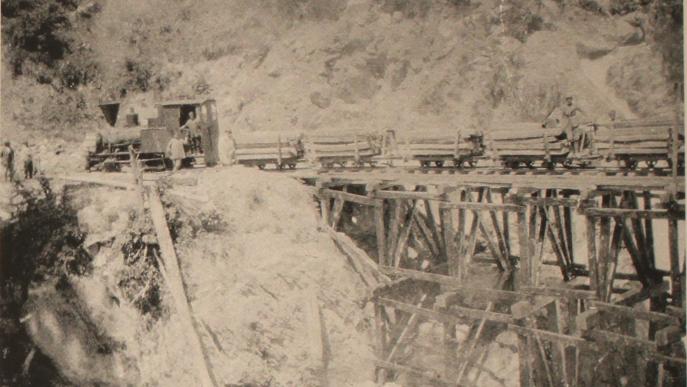 The Decauville train in full load is moving along the bridge. Photographic Archive of Takis Mpaitsis