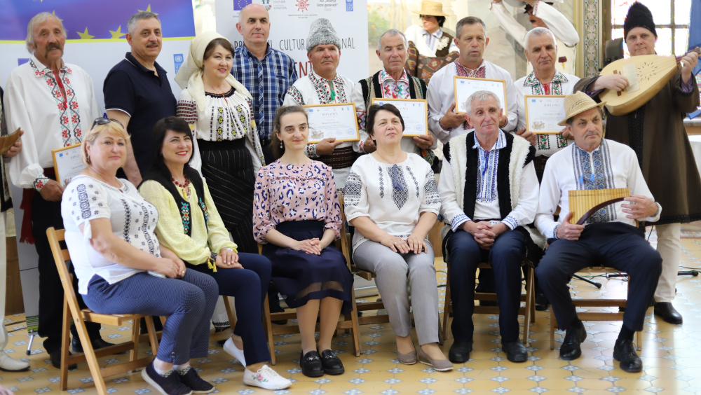 Victor Botnaru, master of art, professor Academy of Music, theater and plastic arts, in a picture of history together with musicians from villages, folk craftsmen, journalists