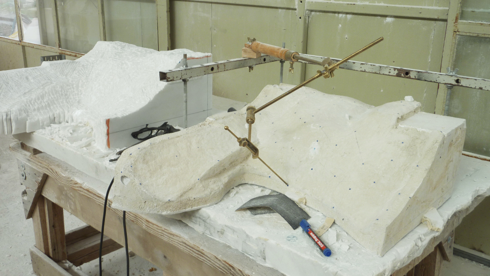 A cast  and its marble copy during the process of copying.