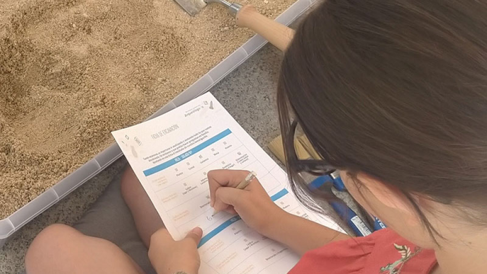 Child participating in an archaeology workshop