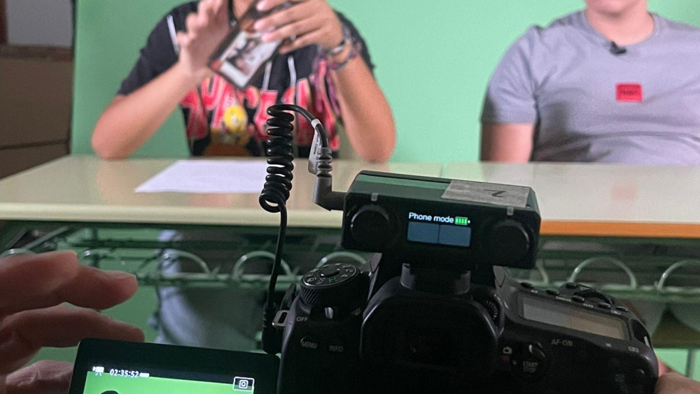 Filming against a green screen to later build our news set.