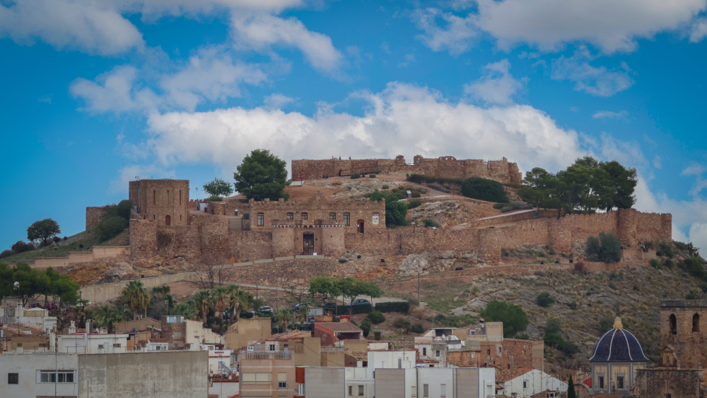 "Scenic view of Onda Castle, a historic fortress atop a hill, overlooking the town with its stone walls and medieval structures."