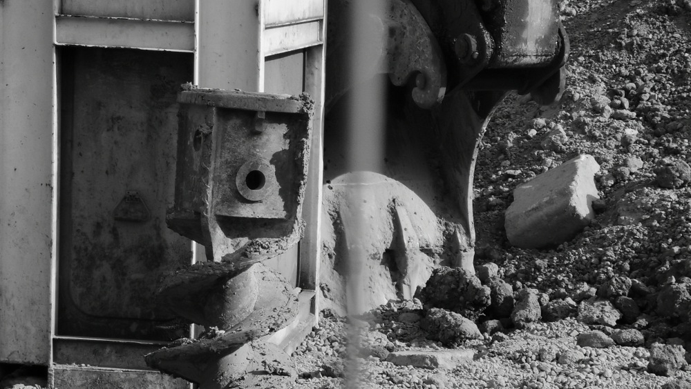 It is a black and white image of a digger, because all is in a process of construction.