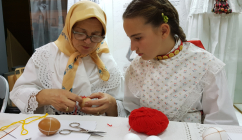 Woman showing to a girl how to die eggs for Easter, Title Keepers of Croatian extended families’ tradition (photo credit, Družina)