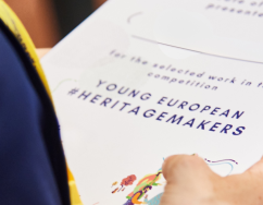 Young European Heritage Makers recognition certificate holding in hand 