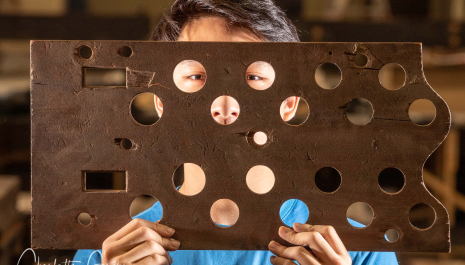 Liverpool Blue Coat School Organ Scholar SIMON CHEUNG with an organ pipe rack from the dismantled Father Willis organ photographed for The Daily Telegraph national UK news paper. 