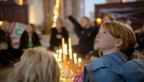 Children looking at the church with many cozy lights