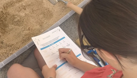 Child participating in an archaeology workshop