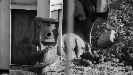 It is a black and white image of a digger, because all is in a process of construction.