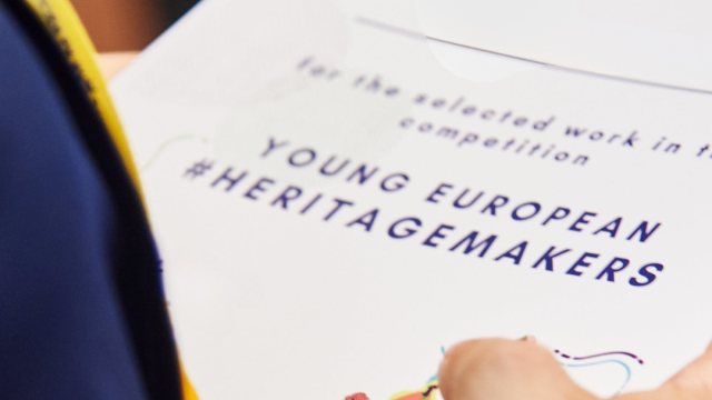Young European Heritage Makers recognition certificate holding in hand 